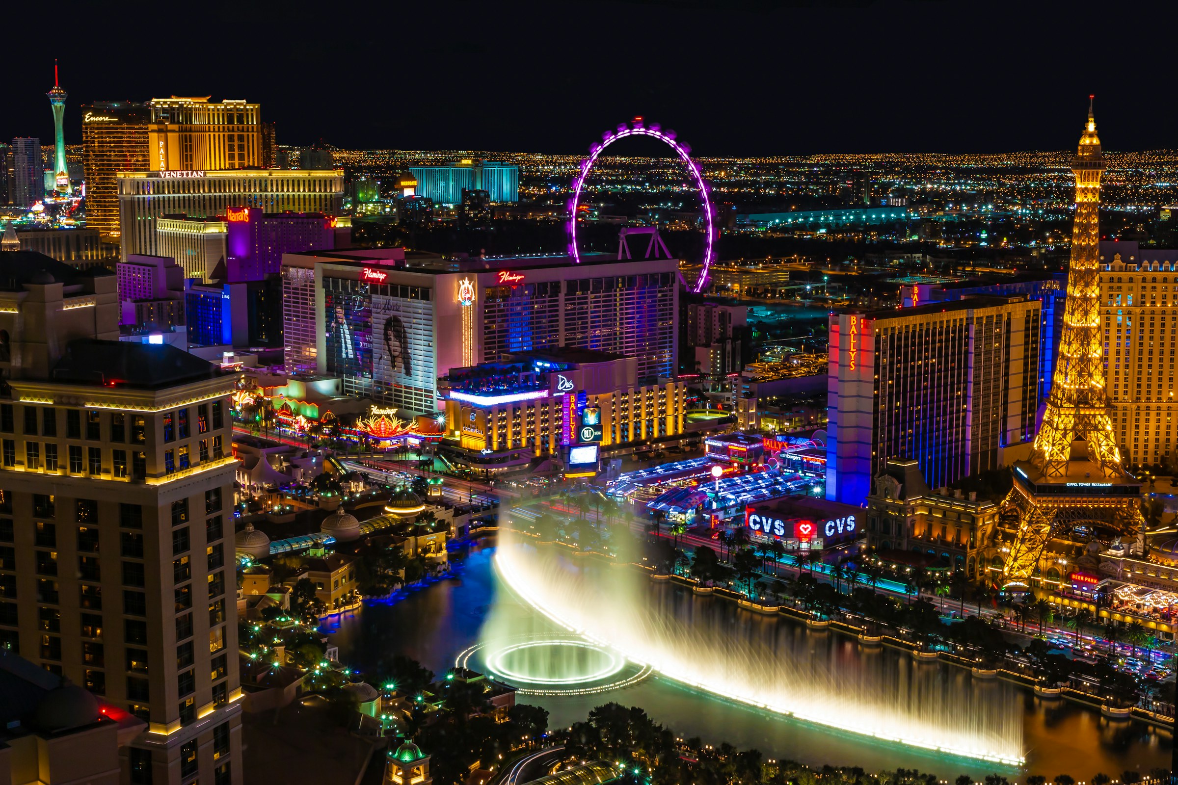 The Las Vegas Strip at night, Bellagio fountains, Paris, High Roller, and the Strip skyline